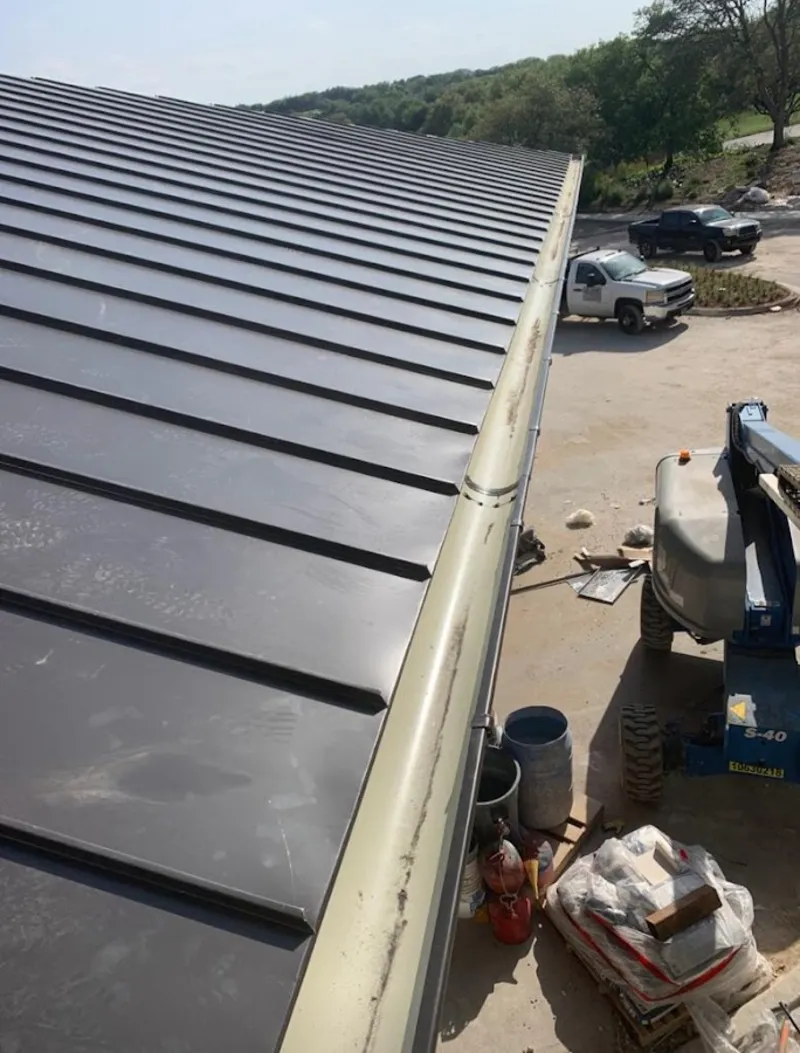 Standing seam panel and gutter detail on a metal roofing jobsite in Washingtonville